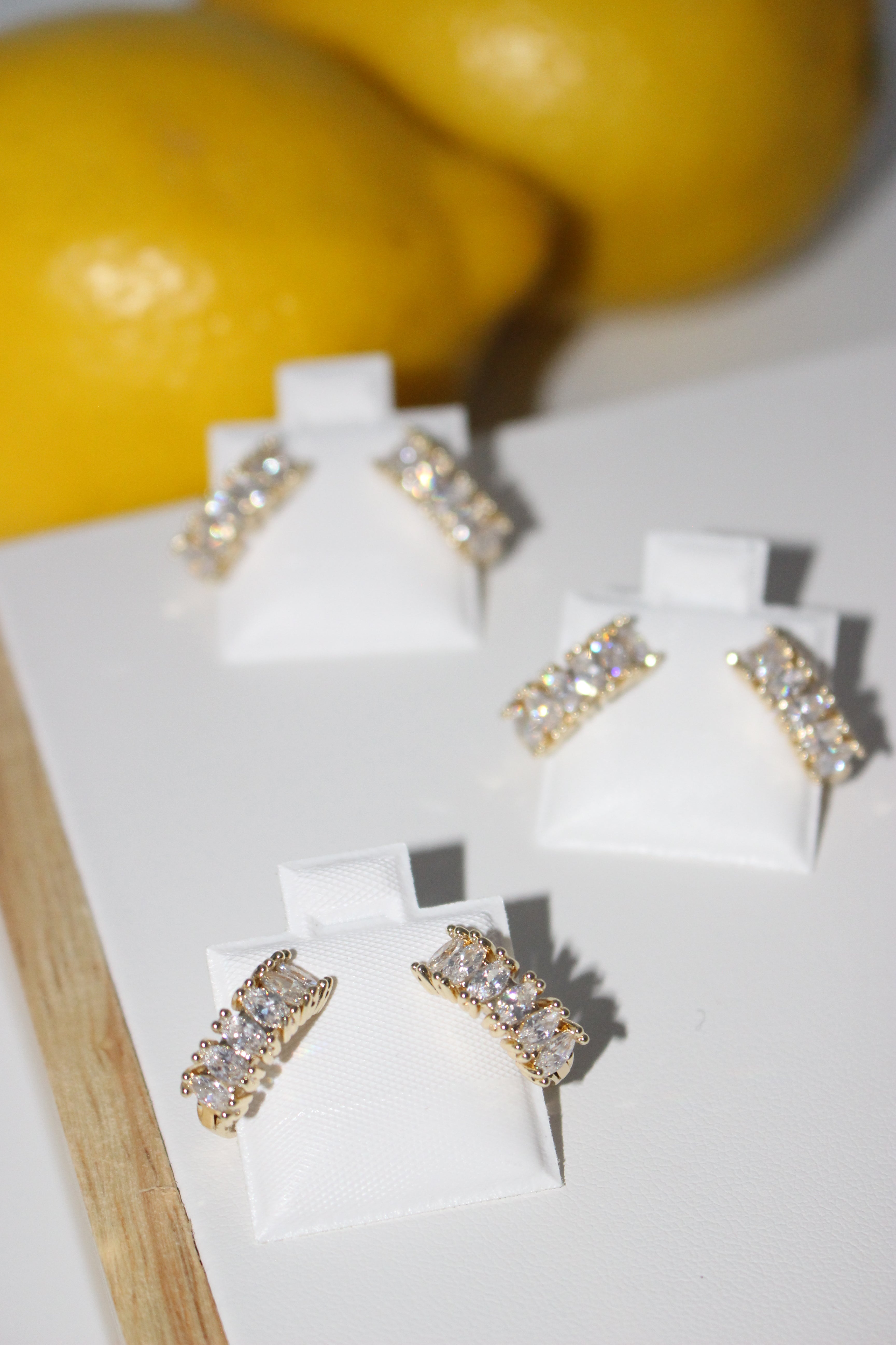 Pair of earrings with diamonds on a light surface.